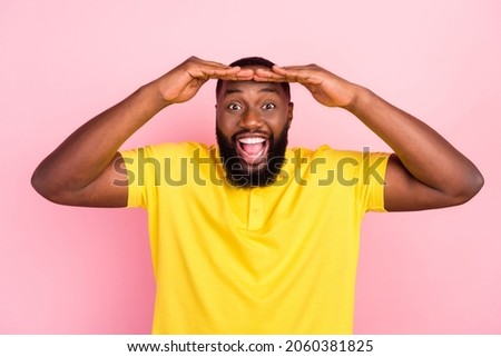 Photo of afro american happy amazed man look forward sale news enjoy isolated on pastel pink color background