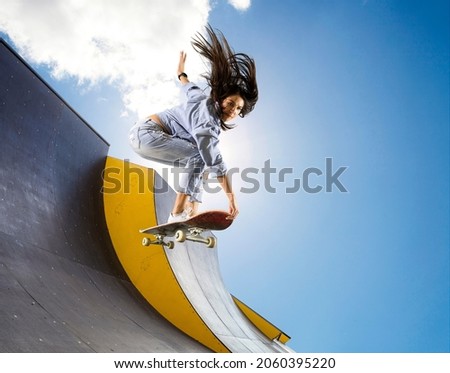 Skateboarder doing a jumping trick. Freestyle extreme sports concept Royalty-Free Stock Photo #2060395220