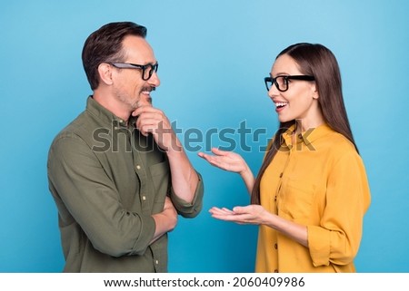 Photo of cheerful happy people partners talk smile conversation glasses isolated on blue color background Royalty-Free Stock Photo #2060409986