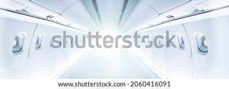 Internal empty salon view of a passenger civil aircraft full with light and illumination Royalty-Free Stock Photo #2060416091