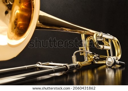 Trombone with transposer mounted on a white table. Front view. Horizontal composition. Royalty-Free Stock Photo #2060431862