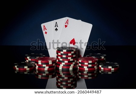 Poker game with three of kind or set combination. Chips and cards on black table. Successful and win three aces Royalty-Free Stock Photo #2060449487