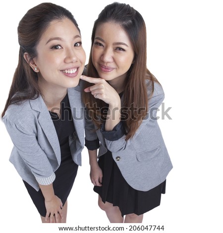 Two beautiful businesswomen having a happy post take a photo isolated on white background