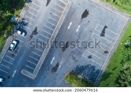 Aerial view top down of car parking lot with white line of traffic sign on the street. Above view of car in a row at parking space Outside car parking area.