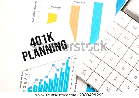 financing availabe text concept. Office workplace table with calculator, graphs, reports and the text 401K Planning on a small piece of paper on multicolored background.