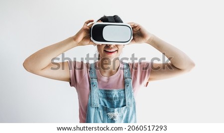 young latin woman with glasses of virtual reality on a white background. Future technology concept. Modern imaging technology in Latin America