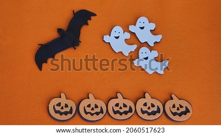 Happy Halloween concept. Halloween decoration on orange background.