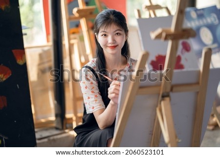 The girl is drawing in the studio