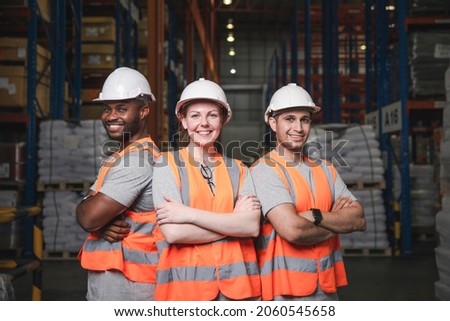 Group of smiling worker standing together at logistic distribution warehouse, Teamwork concept