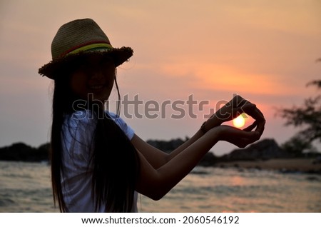 Asian travelers thai women people travel visit and posing for take photo with view landscape seascape of Kung Wiman sand beach and wave water in sea ocean at sunset dusk time at Chanthaburi, Thailand