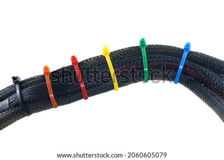 Black braided wires or Expandable Sleeving with cable ties isolated on white background.With clipping path. Royalty-Free Stock Photo #2060605079