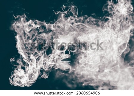 Scary skull emerging from a cloud of smoke . Halloween background.