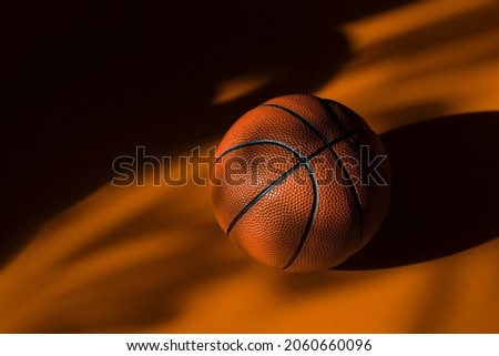 New basketball ball on orange court floor with natural lighting. Workout online concept. Horizontal sport poster, greeting cards, headers, website and app