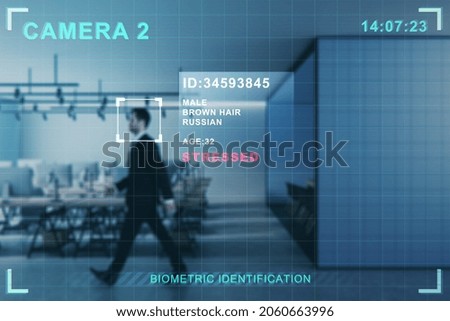 Security camera recognizing attractive young european businessman walking in blurry office interior. ID, scanning and cctv concept. Double exposure Royalty-Free Stock Photo #2060663996