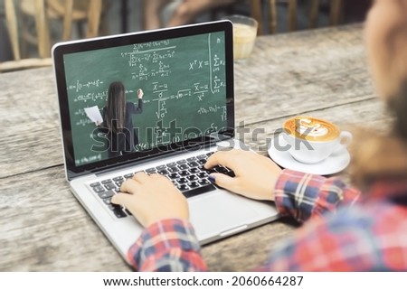 Close up of young casual woman hands using laptop keyboard at wooden cafe table with coffee cup and online education chalkboard and formulas pattern on screen. Digital knowledge and webinar concept