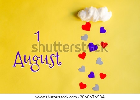 1 august day of month, colorful hearts rain from white cotton cloud on yellow background. Valentine's day, love and wedding concept