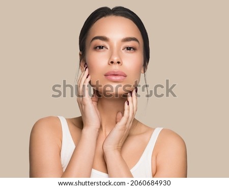 Beautiful woman close up face asian girl with clean fresh healthy skin. Color background. Brown