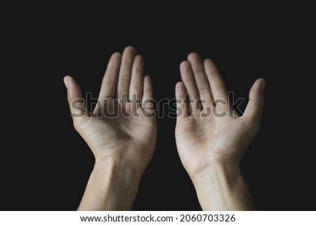 Praying hands. Black background. Make a wish in God. Faith in religion and belief in God on the power of hope or love and devotion.
