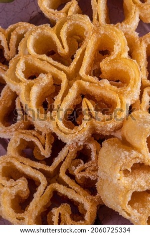Sweet rosette flowers fried with sugar typical of Extremadura, Andalusia and Castilla, Spain. Christmas, Easter, Carnival. Vertical photo and selective focus