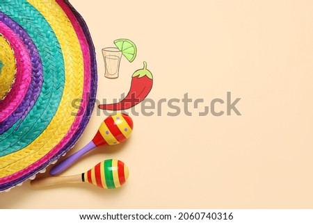 Mexican maracas, sombrero, paper tequila and chili pepper on color background