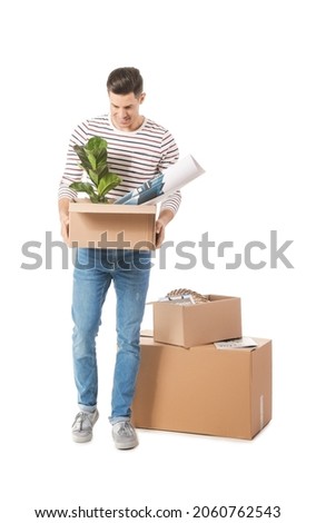 Handsome man with moving boxes on white background