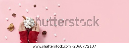 Winter drink, white mug with marshmallows in female hands in knitted Christmas Sweater on pink background. Top view, Flat Lay. New Year, Christmas traditional food. Festive decor, celebration Xmas Royalty-Free Stock Photo #2060772137