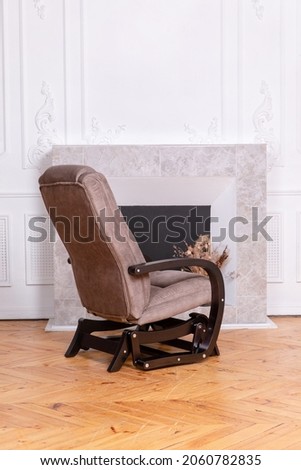 beige brown armchair comfortable home cozy fireplace office comfort books shelf plaster figures statues white background wooden chair sofa comfort textured wall natural parquet rocking chair marble