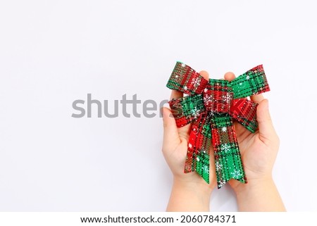 hand holding a christmas bow