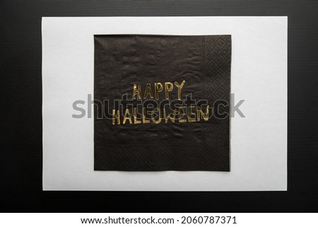 Top view a Napkin written "Happy Halloween" on dark background. Copy space