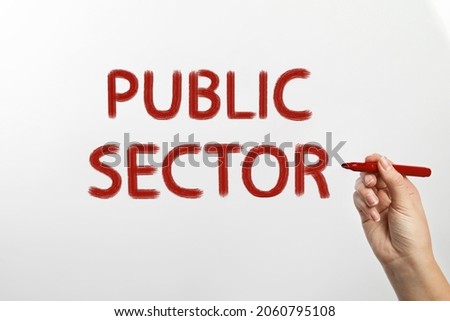 Woman writing phrase PUBLIC SECTOR on glass against white background, closeup