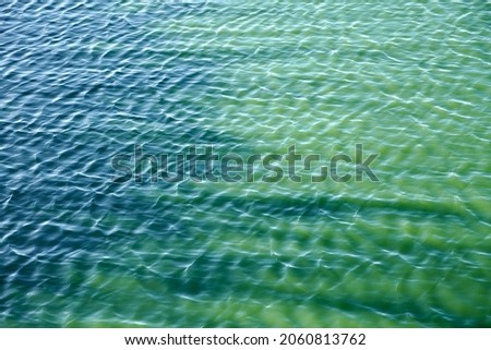 Sea water wave effect. Turquoise calm clean aqua surface. Blue rippling water. Minimalist. Sparkling water background. Texture effect wallpaper.