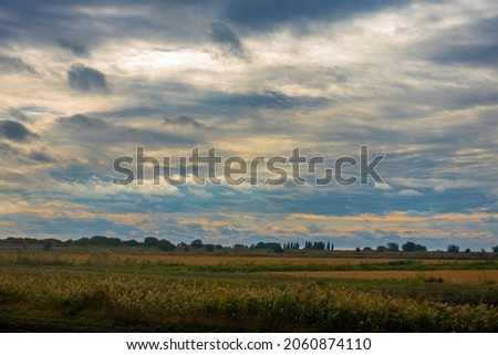 sunrise and clouds over the field in early autumn