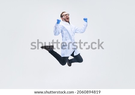 Win, success. One excited man, chemist, doctor jumping isolated on white background. Concept of healthcare, pharmaceuticals, medicine. Copy space for ad. Looks happy. Wow emotions Royalty-Free Stock Photo #2060894819
