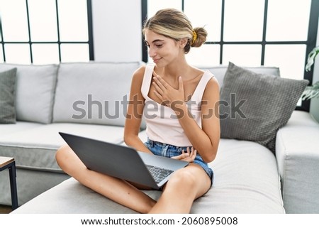 Young caucasian woman having video call communicating with deaf language at home