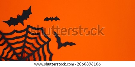 Happy Halloween. Paper bats on an orange background. Place for text. Banner format