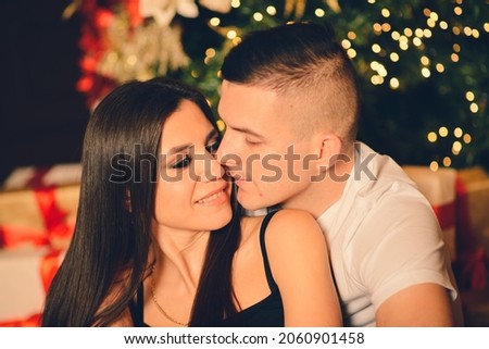 Man surprise woman for Chrismas, loving and kissing couple