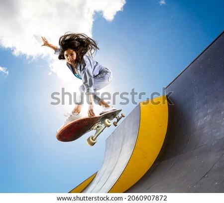 Skateboarder doing a jumping trick. Freestyle extreme sports concept Royalty-Free Stock Photo #2060907872