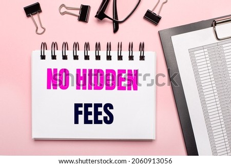 On a pink background, reports, black paper clips, glasses and a white notebook with the text NO HIDDEN FEES.
