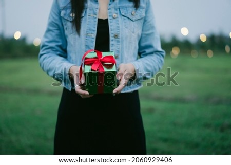 A picture of a girl holding a Christmas present in China