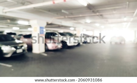 Abstract Blurry line of cars in the parking of shopping mall. Right copy space for text
