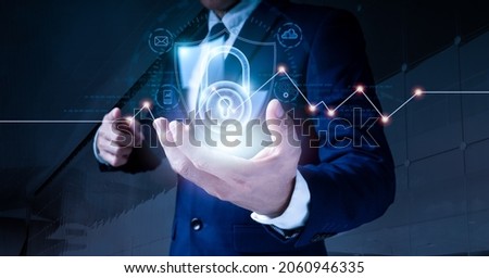 Data protection and cyber security. A padlock is used by a businessman to secure commercial and financial data over a virtual network connection. Innovative technology produce brilliant solutions. Royalty-Free Stock Photo #2060946335