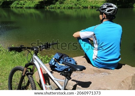 Mountain biker take a break at a lake (model released)