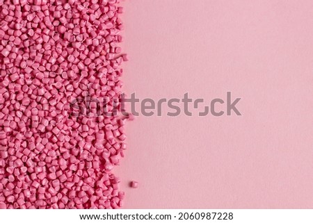 Pink granules of polypropylene or polyamide. background. Plastics and polymers industry. Monochrome Royalty-Free Stock Photo #2060987228