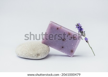 Lavender soap on the pedestal from sea stone on light background.