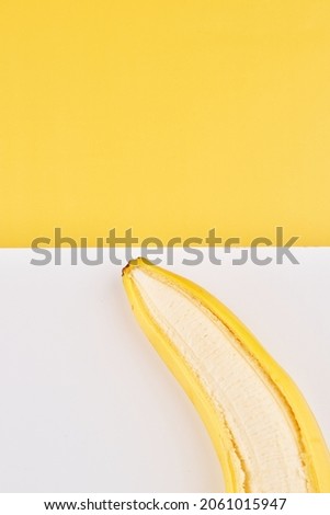 Creative geometric background with bananas. Yellow white backdrop wallpaper