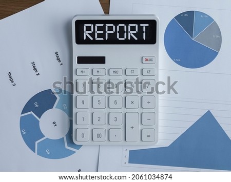 Financial report concept. Word on calculator and finance documents.