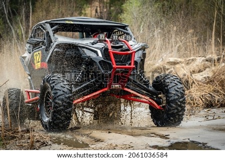 ATV, UTV, 4x4 off-road vehicle in muddy water Royalty-Free Stock Photo #2061036584