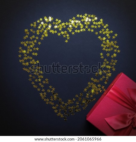 Valentine's Day card. Festive romantic picture with a shiny heart and a gift box. Flatlay composition