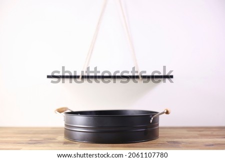 A studio photo of a black metal drinks tray