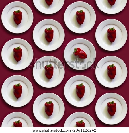 Pattern Red bell pepper on the white plate on the red background. Minimalism Top view, flat lay. exceptional and extraordinary concept